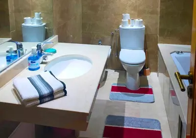 a bathroom with a white sink and a toilet at Appartement spacieux in Marrakech