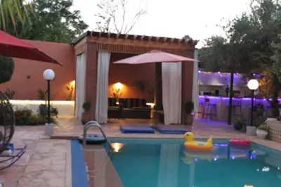 a swimming pool with a rubber duck in the water at Villa Gardens Diafa in Marrakech