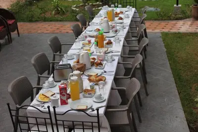a long table with plates of food on it at Villa Gardens Diafa in Marrakech