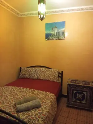 a bedroom with a bed and a picture on the wall at appartement Bahia jame el fna in Marrakech