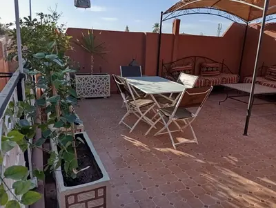 a patio with a table and chairs and a tent at appartement Bahia jame el fna in Marrakech