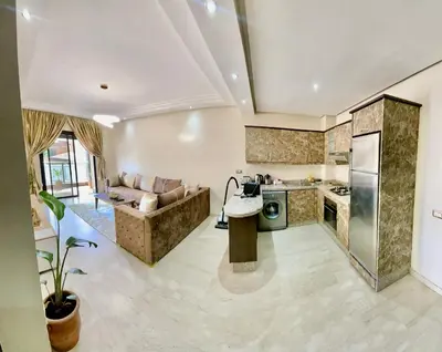 a kitchen and living room with a couch and a table at Golden house in Marrakech