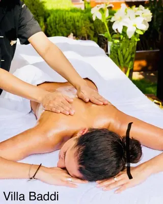 a woman getting a massage on a bed at Villa Baddi Marrakech in Marrakech