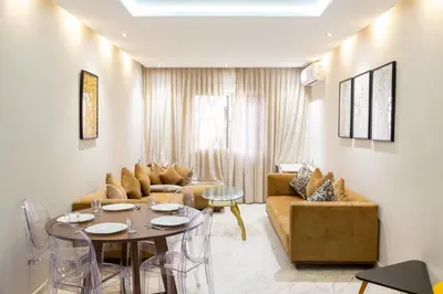 a living room with a couch and a table at A Place To Call Home - Downtown in Marrakech