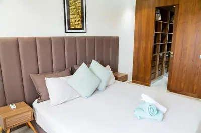 a bedroom with a bed with towels on it at A Place To Call Home - Downtown in Marrakech