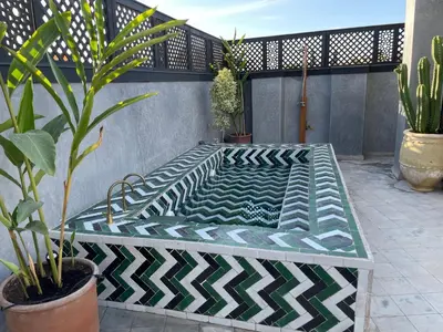 a bench sitting on a patio with plants at YVES Marrakech in Marrakech