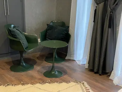 two green chairs and a table in a room at YVES Marrakech in Marrakech