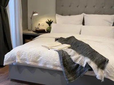 a bed with a blanket and a book on it at YVES Marrakech in Marrakech