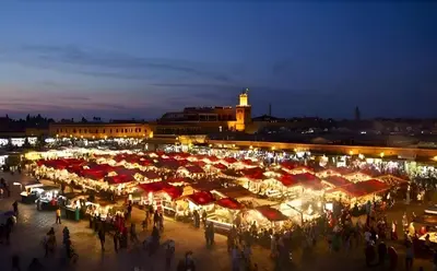 a crowd of people standing around a market at night at Élégant Refuge à Deux Pas du Célèbre Jardin Majorelle in Marrakech