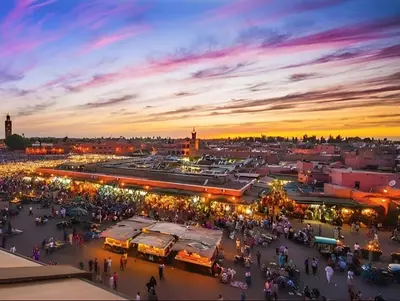 a crowd of people walking around a market at sunset at Élégant Refuge à Deux Pas du Célèbre Jardin Majorelle in Marrakech