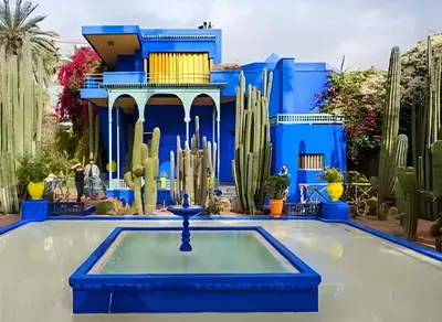 a blue house with a pool and cactus at Élégant Refuge à Deux Pas du Célèbre Jardin Majorelle in Marrakech