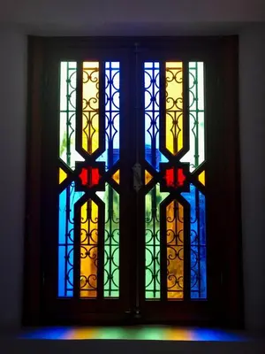a window with colorful stained glass windows in a room at Riad Amely in Marrakech