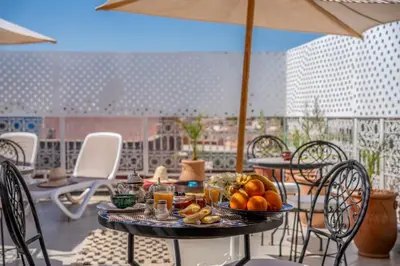 a table with fruit on it on a patio at Riad HAFSSA & Spa in Marrakech