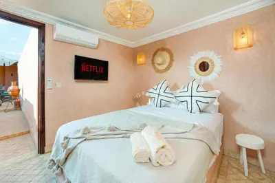 a bedroom with a bed with towels on it at Riad Privé Dar L'Étoile - Jacuzzi Piscine & Petit Déj inclus in Marrakech