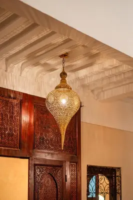 a chandelier hanging over a wooden door at Riad Privé Dar L'Étoile - Jacuzzi Piscine & Petit Déj inclus in Marrakech