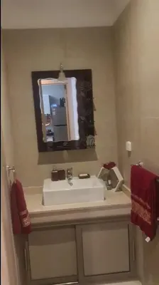 a bathroom with a sink and a mirror at Magnifique Appartement lux - Perles de Coralia in Marrakech