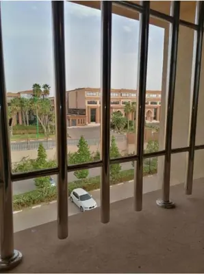a white car is parked outside of a window at Magnifique Appartement lux - Perles de Coralia in Marrakech