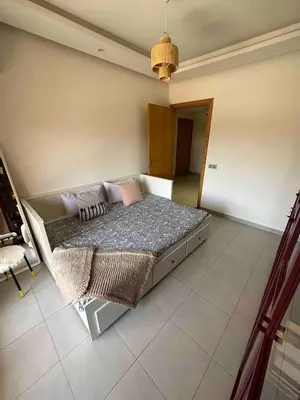 a bedroom with a bed with pillows on it at Jardin Majorelle Cozy Apartment in Marrakech