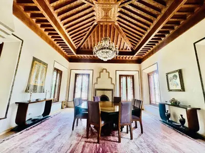 a dining room with a table and chairs and a chandelier at Majestic Luxury Villa Marrakech in Marrakech