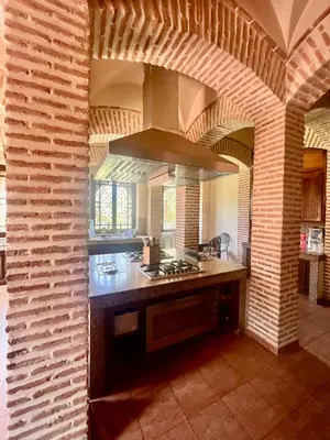 a kitchen with a stove top oven in a room at Majestic Luxury Villa Marrakech in Marrakech