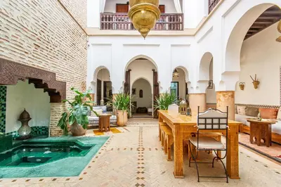a courtyard with a pool in the middle of a building at Riad El Faris Exclusif-Included Moroccan Breakfast in Marrakech