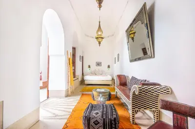 a living room with a couch and a table at Riad El Faris Exclusif-Included Moroccan Breakfast in Marrakech