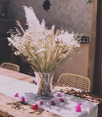a vase of white flowers sitting on a table at Riad of The Light in Marrakech