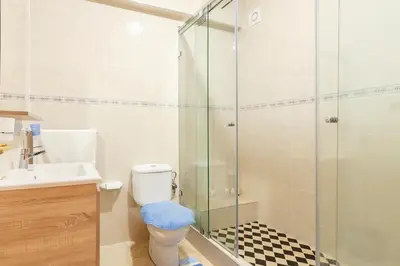 a bathroom with a toilet and a glass shower at Appartement spacieux Centre Marrakech in Marrakech