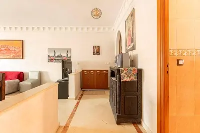 a living room with a couch and a refrigerator at Appartement spacieux Centre Marrakech in Marrakech
