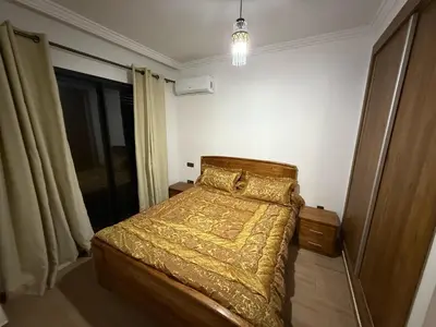 a bedroom with a bed with a gold bedspread at Appartement Nour 5 Marrakech in Marrakech