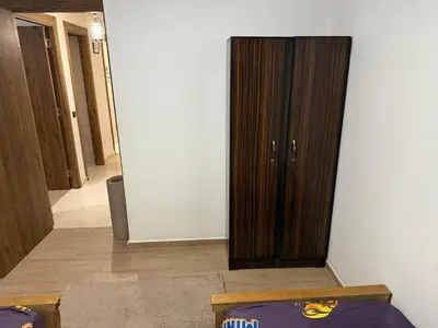 a living room with a wooden cabinet in a room at Appartement Nour 5 Marrakech in Marrakech