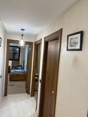 a hallway with several doors and a bedroom at Appartement Nour 5 Marrakech in Marrakech