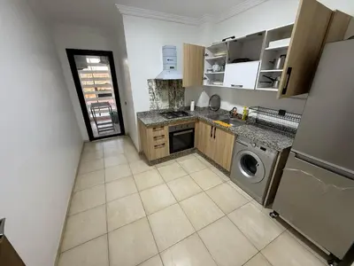 a kitchen with a washer and dryer in a room at Appartement Nour 5 Marrakech in Marrakech