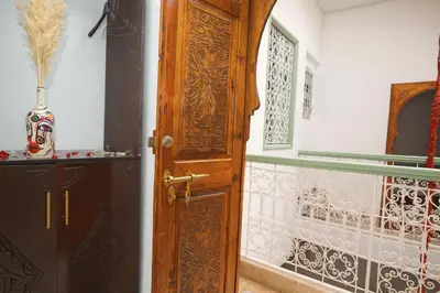 a wooden door in a room with a wall at Riad Safran Rouge Jacuzzi RoofTop in Marrakech