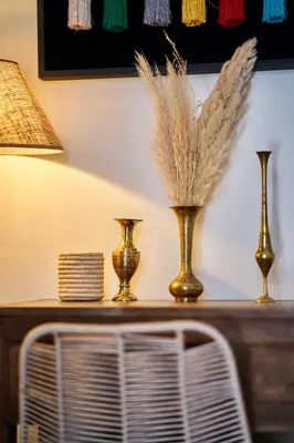 a table with three vases and a lamp on it at Riad IMPERIA in Marrakech