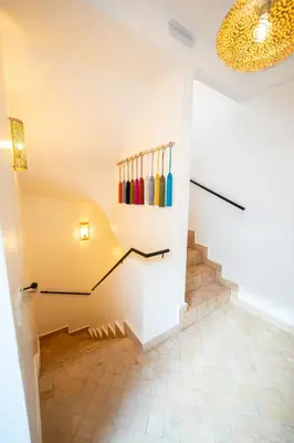 a room with a staircase with colorfulcolored bowls on the wall at Riad IMPERIA in Marrakech