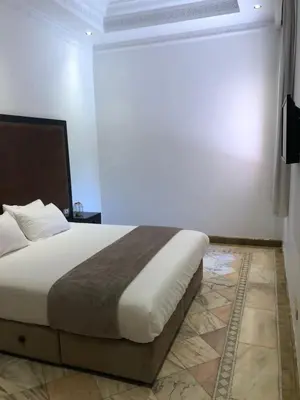 a bedroom with a large bed in a room at Palmeraie Village 2 - Cosi appartement en Rez de Jardin in Marrakech