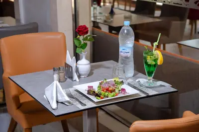 a table with a plate of food and a drink on it at Hotel Palais Al Bahja in Marrakech