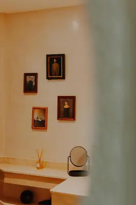 a room with three pictures on the wall and a chair at Le Petit Kenzara & magical rooftop in Marrakech