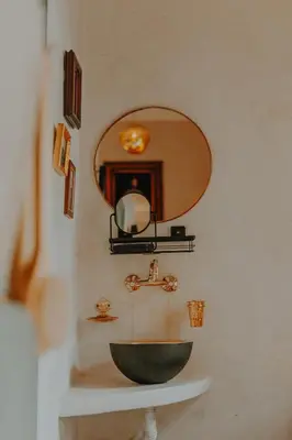 a bathroom with a black sink and a mirror at Le Petit Kenzara & magical rooftop in Marrakech