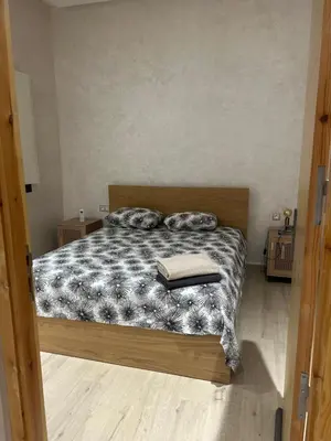a bedroom with a bed with two pillows on it at Villa 5 chambres route de Casablanca Marrakech in Marrakech