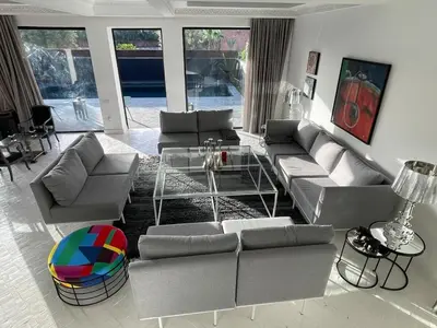 a living room with couches and a table at La Villa 2A, Palmeraie, Marrakech in Marrakech