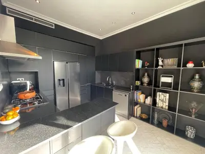 a kitchen with a stainless steel refrigerator and gray walls at La Villa 2A, Palmeraie, Marrakech in Marrakech