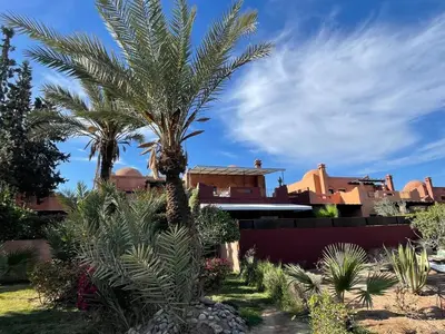 a palm tree in front of a house at La Villa 2A, Palmeraie, Marrakech in Marrakech