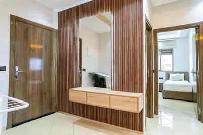 a bathroom with a bath tub in a room with a bed at L'horizon Aéroport Appartement in Marrakech