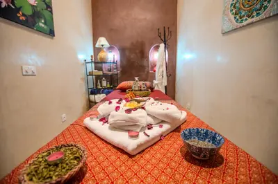 a bedroom with a bed with towels and bowls on it at Riad Mandana & Spa in Marrakech