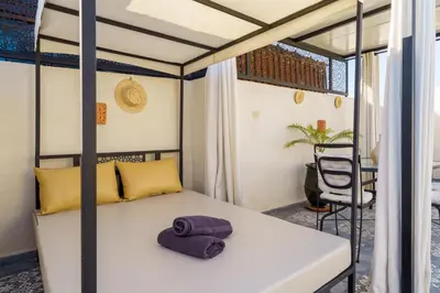 a bed with a purple towel on it in a room at Riad AJI 4 Rooms, Pool, Internet, Top Emplacement Médina in Marrakech