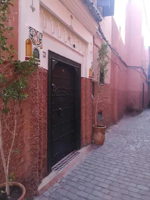 a black door on the side of a building at Riad El Badii chambre queen size Badii in Marrakech