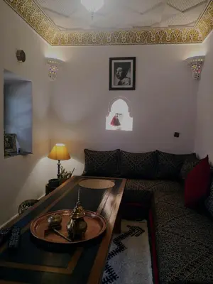 a living room with a couch and a table at Riad El Badii chambre queen size Badii in Marrakech