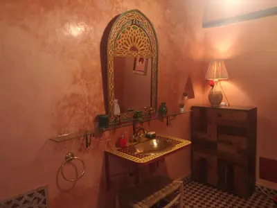 a bathroom with a sink and a mirror at Riad El Badii chambre queen size Badii in Marrakech